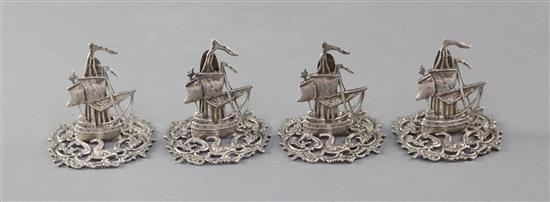 A set of four Edwardian novelty silver menu holders, modelled as galleons, by James Dudley, Southsea, height 51mm.